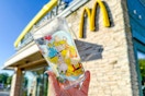 someone holding a collector cup outside of mcdonalds
