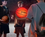 a group of boys holding a glowing basketball