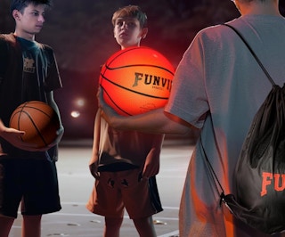 a group of boys holding a glowing basketball