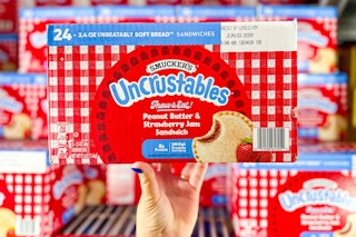 hand holding a box of smuckers strawberry uncrustables