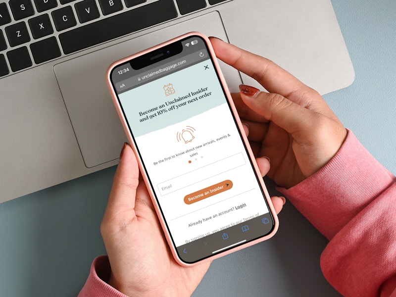 A person looking at the Unclaimed Baggage website email newsletter sign up