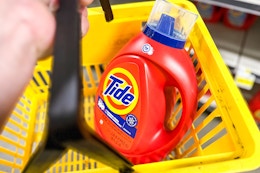 tide laundry detergent in a yellow shopping basket