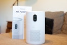 an air purifier next to its packaging 