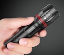 a hand holding a flashlight