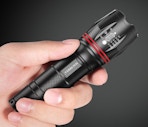 a hand holding a flashlight