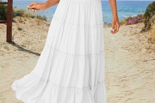 a woman wearing a skirt on the beach