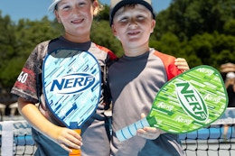 kids at a pickleball court with nerf paddles