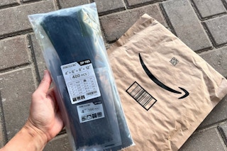 person holding bag of zip ties