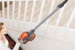 woman using shark vacuum on stairway