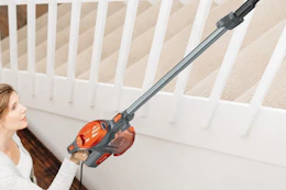 woman using shark vacuum on stairway