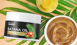 two jars of batana oil on a palm leaf