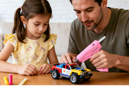 adult repairing toy car with hot glue gun