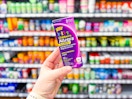 Lifestyle image of children's Allegra allergy medicine held up in medicine aisle at Walmart