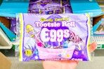 hand holding up a bag of tootsie roll eggs