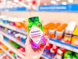 hand holding a bottle of vitafusion melatonin at target