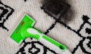 a pet hair removal tool on a rug