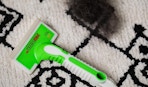 a pet hair removal tool on a rug