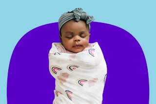 Small baby wrapped up in a Red Rovr swaddle blanket in one of the blankets from the "Little Unircorns" set