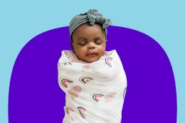 Small baby wrapped up in a Red Rovr swaddle blanket in one of the blankets from the "Little Unircorns" set