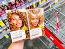 person holding 2 clairol hair colors over a cart