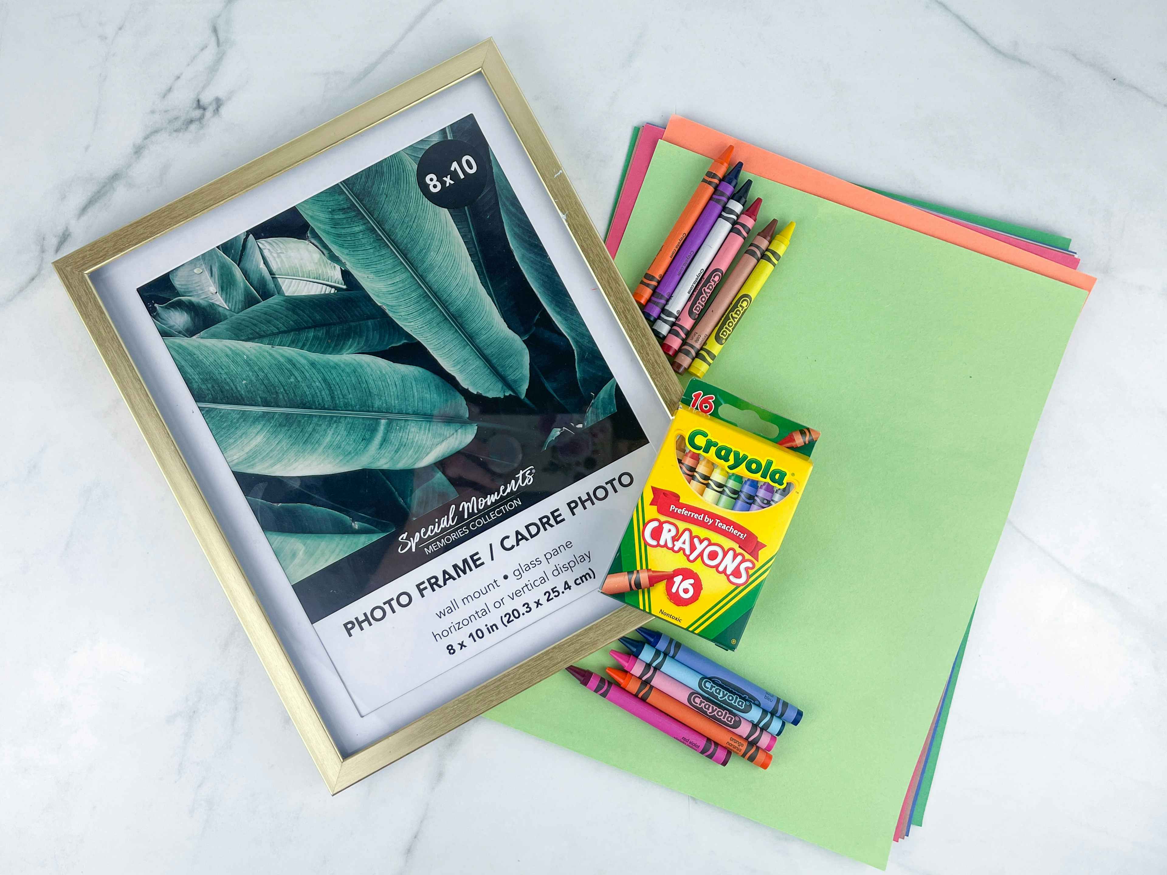 items on a counter to make a framed crayon art teacher gift