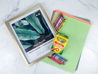 items on a counter to make a framed crayon art teacher gift