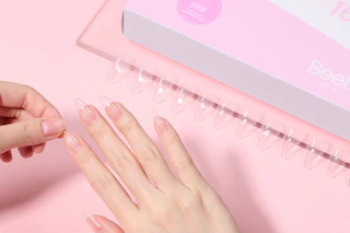 a woman applying beetles nails