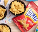 Bugle chips in bowls next to a bag of Bugles
