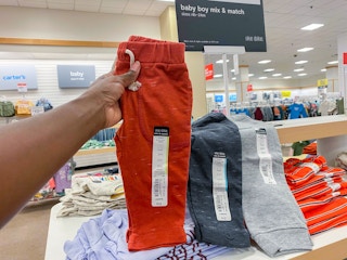 hand holding baby boy fleece pants