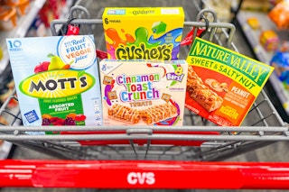 motts fruit snacks, gushers, general mills cereal bars, and nature valley granola bars in a cart