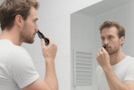 a man using a nose hair trimmer