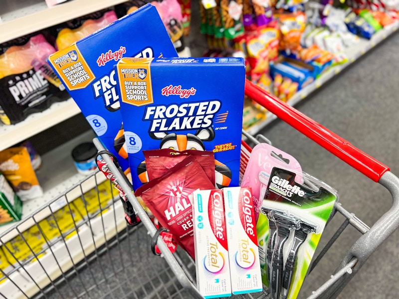 frosted flakes, colgate toothpaste, cough drops, and razors in a cart