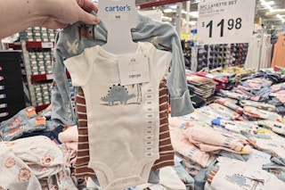 person holding a carters outfit set