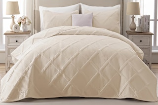 Lifestyle image of Exclusivo Mezcla King 3-piece Bed Set displayed on bed in bedroom