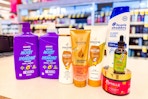 pantene, aussie, mielle, and head & shoulders hair care products on a store counter