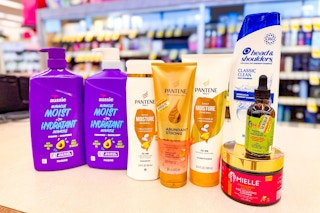 pantene, aussie, mielle, and head & shoulders hair care products on a store counter