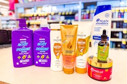 pantene, aussie, mielle, and head & shoulders hair care products on a store counter