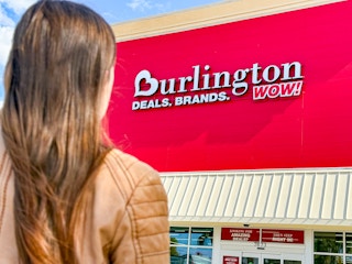 a woman walking up to a Burlington store