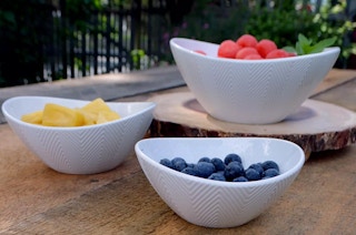 a bowl set with fruit in them