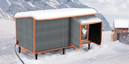 a cat in a heated cat house in the snow outside