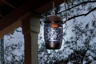a bug zapper hanging on the porch of a house