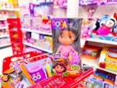 3 dora toys sitting on a target cart
