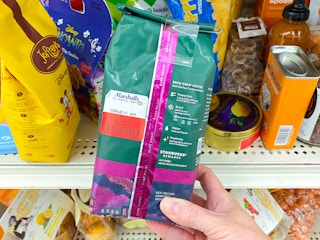 person holding bag of clearance starbucks coffee in marshalls store