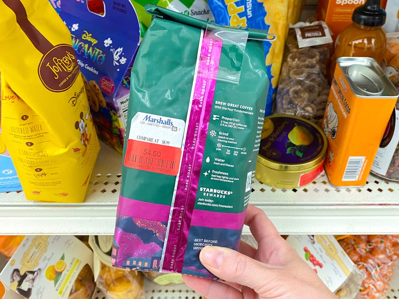 person holding bag of clearance starbucks coffee in marshalls store