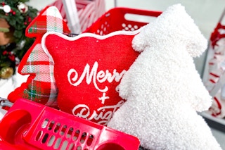 holiday throw pillows in a red shopping cart