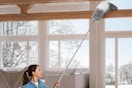 a woman using a duster