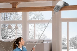 a woman using a duster