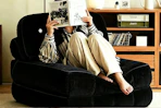 woman sitting on black folding sofa