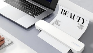 a laptop next to a wireless printer