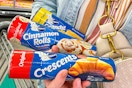 person holding pillsbury grands biscuits crescents and cinnamon rolls